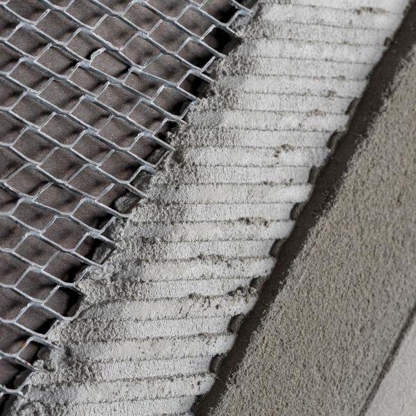 Expanded metal lath is secured inside the concrete wall for reinforcement.