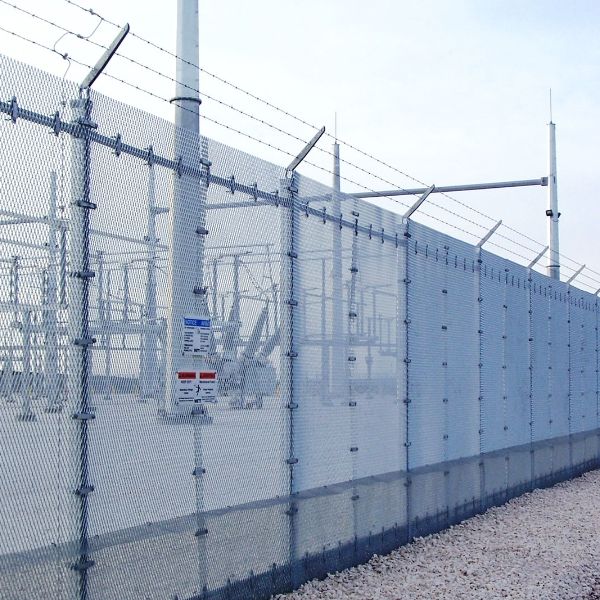 Expanded metal security fence is set up along the substation.