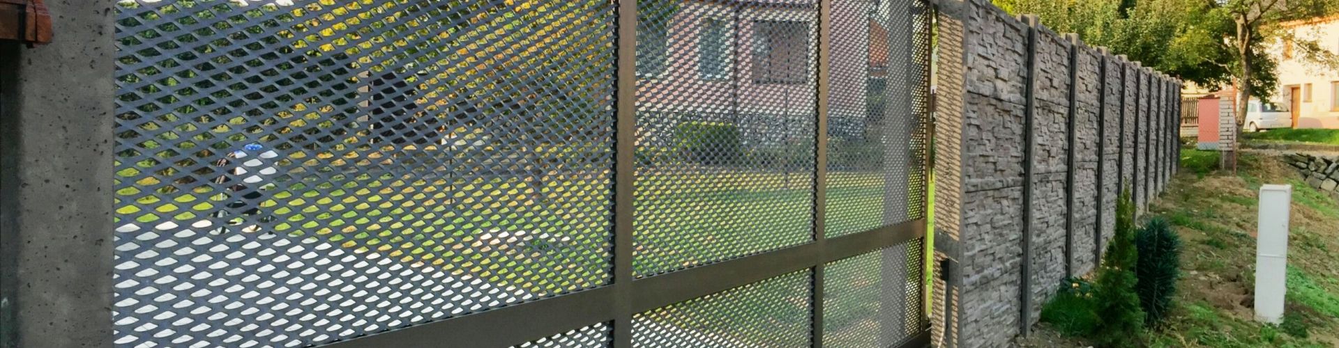 Expanded metal security fence is installed around the perimeter of residential community.