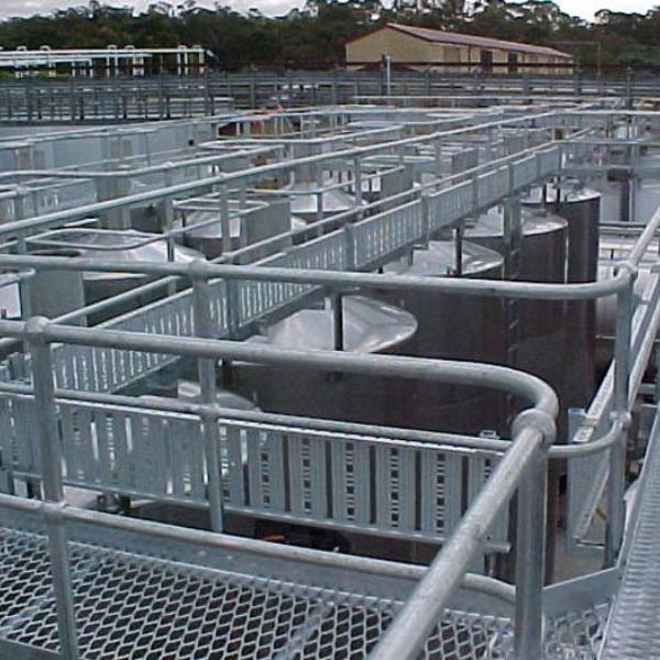 Expanded metal walkway is established around the industrial facilities.