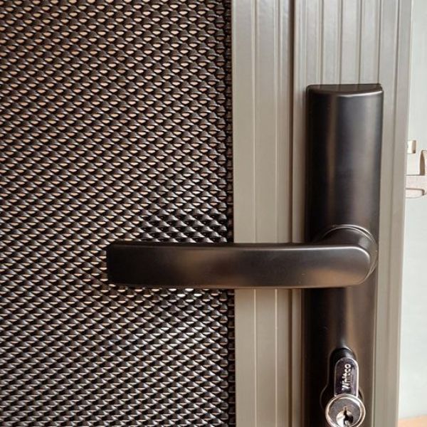 Partial details of heavy duty DVA mesh security door with handle