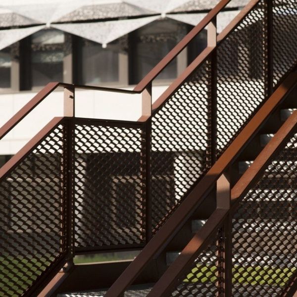 Outdoor stairs are equipped with expanded metal handrails.