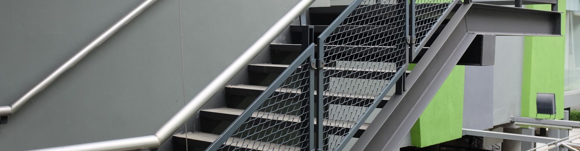 Outdoor railings are made of expanded metal infill panels.